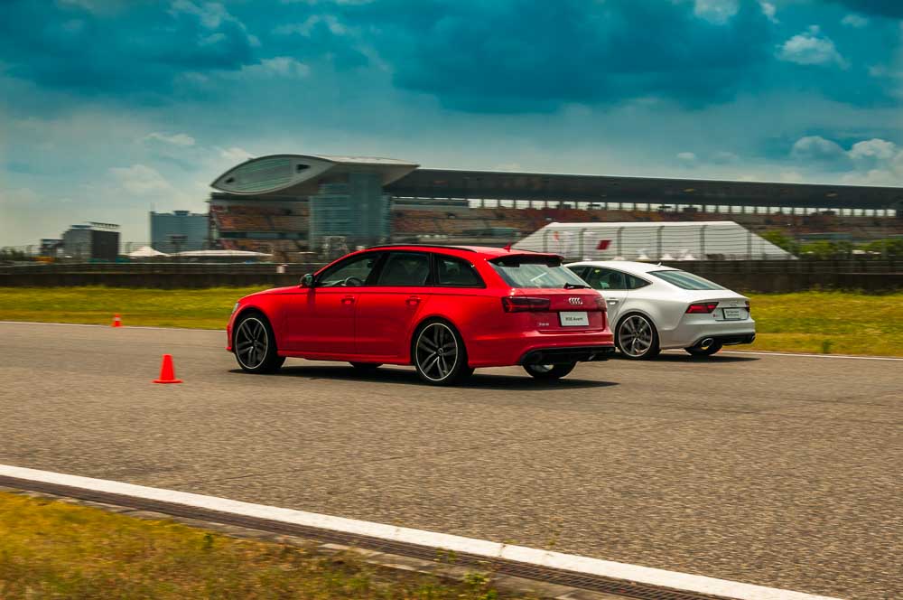 South China Morning Post. Blue skies, shimmering asphalt and powerful Audis in Shanghai.