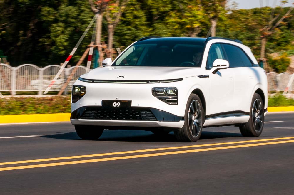 Long range 4WD performance version of the XPeng G9 electric SUV being driven on the road in Shanghai, China.