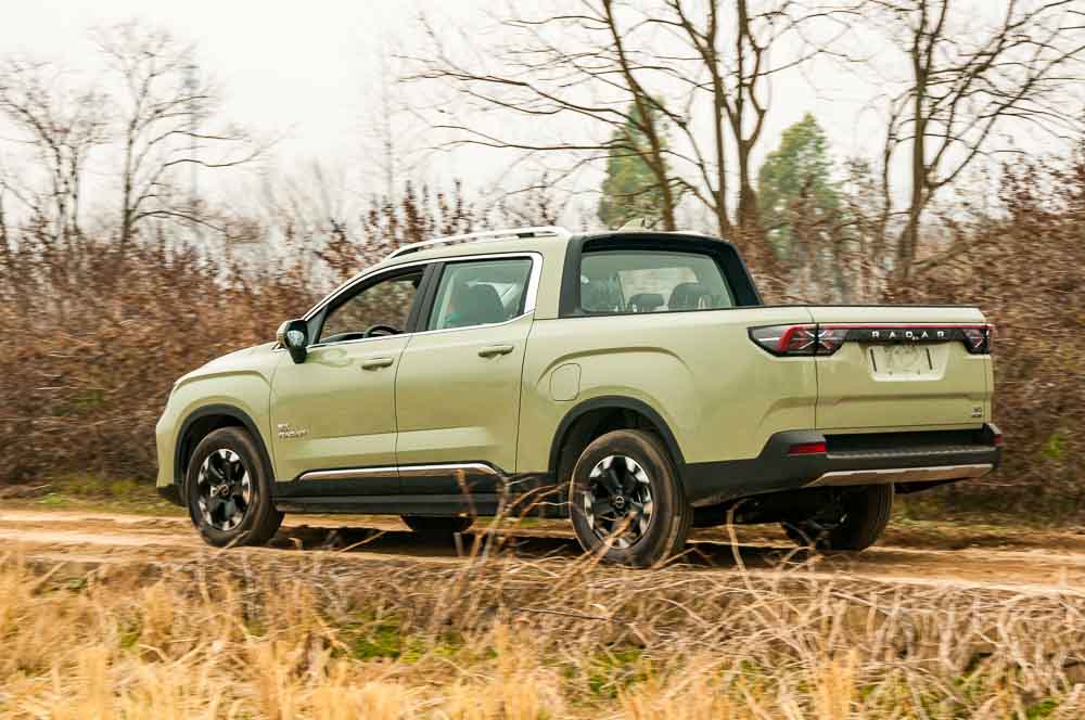 Zhejiang Province, China – 28122022: Radar RD6 electric pickup truck being driven on a dirt track on a test drive.